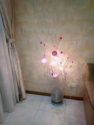 a vase with pink flowers in a room at Sekinchan HighLevel SeaView Homestay \u9ad8\u697c \u770b\u6d77 \u9633\u53f0\u6c11\u5bbf in Sekincan
