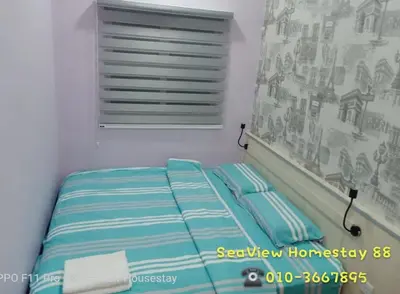 a small bed in a room with a window at Sekinchan HighLevel SeaView Homestay \u9ad8\u697c \u770b\u6d77 \u9633\u53f0\u6c11\u5bbf in Sekincan