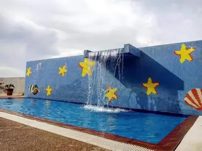 a swimming pool with a waterfall and stars painted on it at Sekinchan HighLevel SeaView Homestay \u9ad8\u697c \u770b\u6d77 \u9633\u53f0\u6c11\u5bbf in Sekincan
