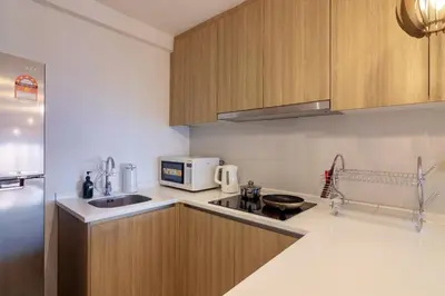 a kitchen with a sink and a microwave at Tropicana 218 X Airlevate Suites in George Town