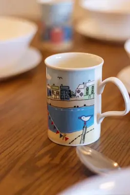 a coffee cup sitting on top of a table at Tropicana 218 X Airlevate Suites in George Town