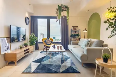 a living room with a couch and a table at Tropicana 218 X Airlevate Suites in George Town