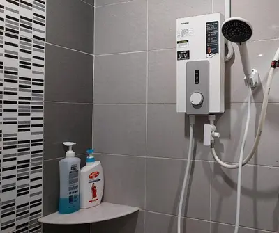 a bathroom with a soap dispenser on a wall at D'Sandra Homestay in Kulim