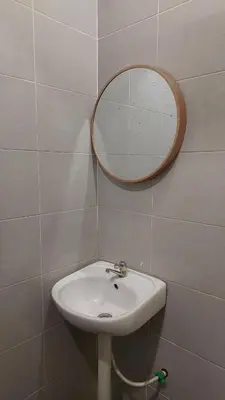 a bathroom with a sink and a mirror on the wall at D'Sandra Homestay in Kulim