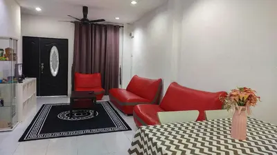 a living room with red chairs and a dining table at D'Sandra Homestay in Kulim
