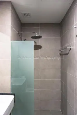 a bathroom with a shower with a glass door at Xandra's 218 Macalister Suite in George Town