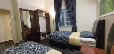 a hotel room with two beds and a mirror at Gerard's 