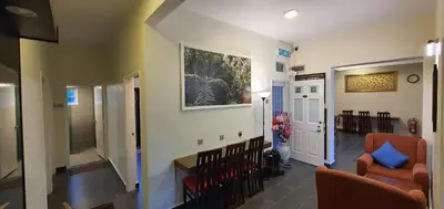 a hallway with a living room with a couch and a chair at Gerard's 