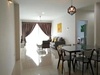 a dining room and living room with a table and chairs at Omni Cassia Hill Resort in Cameron Highlands