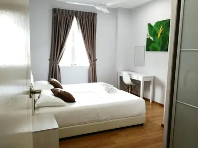 a bedroom with a bed and a desk and a window at Omni Cassia Hill Resort in Cameron Highlands