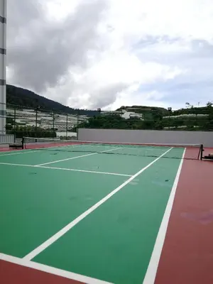 a tennis court with a tennis net on it at Omni Cassia Hill Resort in Cameron Highlands