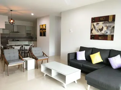 a living room with a couch and a table at Omni Cassia Hill Resort in Cameron Highlands