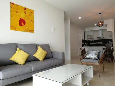a living room with a couch and a table at Omni Cassia Hill Resort in Cameron Highlands