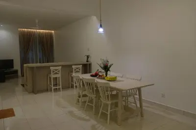 a kitchen with a table and chairs in a room at Brand New Apartment in Local Neighbourhood in Ringlet
