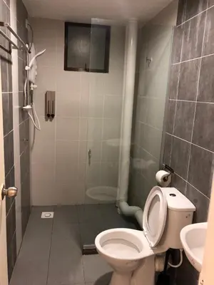 a bathroom with a toilet and a shower and a sink at Brand New Apartment in Local Neighbourhood in Ringlet