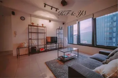 a living room with a couch and a large window at Tropicana 218 Macalister in George Town
