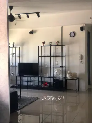 a living room with a flat screen tv on a wall at Tropicana 218 Macalister in George Town