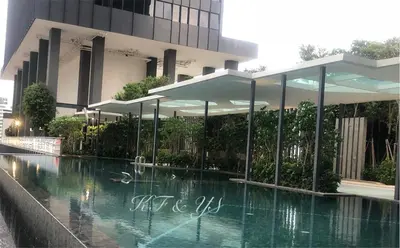 a building with a swimming pool in front of a building at Tropicana 218 Macalister in George Town