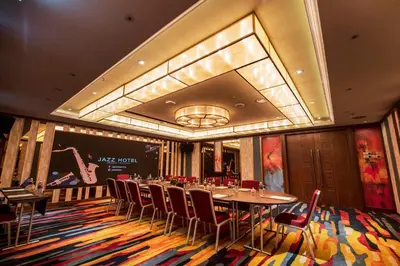 a dining room with a long table and chairs at Jazz Hotel Penang in George Town