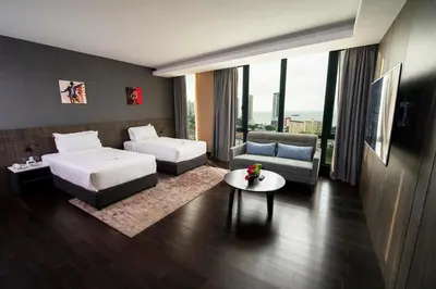 a hotel room with a bed and a couch at Jazz Hotel Penang in George Town
