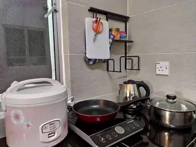 a toaster and a pot on a stove in a kitchen at Plumber house in Tanah Rata