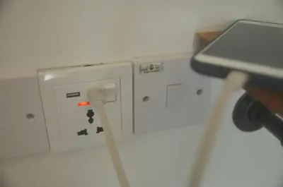an electrical outlet with a stick in a room at Plumber house in Tanah Rata