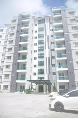 a white car parked in front of a large building at Plumber house in Tanah Rata