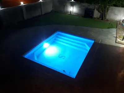 a swimming pool with a blue light in the dark at Safar House & Cabin (Muslim) in Kuala Kangsar