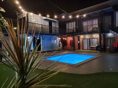 a house with a swimming pool at night at Safar House & Cabin (Muslim) in Kuala Kangsar