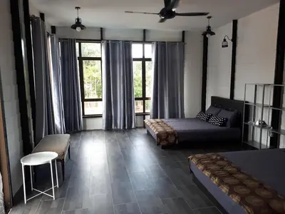 a living room with a bed and a couch at Safar House & Cabin (Muslim) in Kuala Kangsar