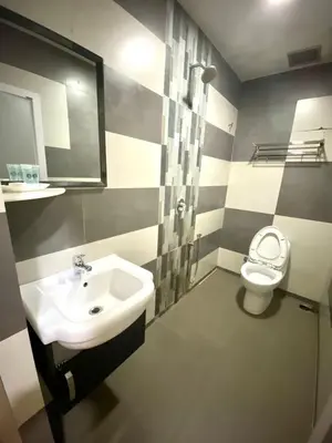 a bathroom with a sink and a toilet at Haji Saudi Hotel in Cameron Highlands