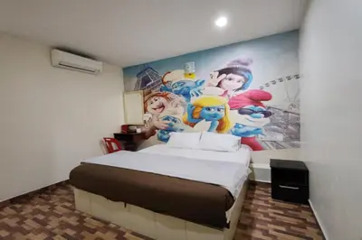 a room with a bed with a painting on the wall at Nova Hotel, Ipoh Tambun in Ipoh