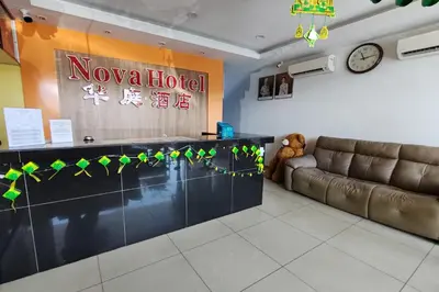 a lobby of a hotel with a couch and a clock at Nova Hotel, Ipoh Tambun in Ipoh
