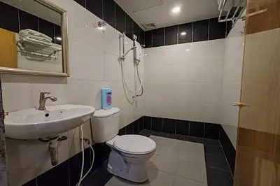 a bathroom with a toilet and a sink at Nova Hotel, Ipoh Tambun in Ipoh