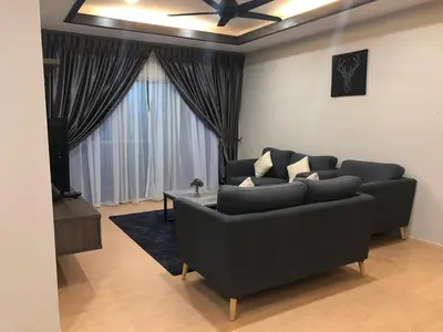 a living room with a couch and a ceiling fan at Meena's Apartment @ The Quintet in Cameron Highlands