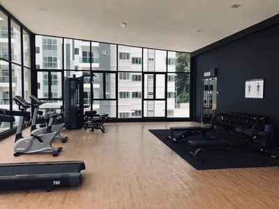 a gym with treadmills and exercise equipment in a building at Meena's Apartment @ The Quintet in Cameron Highlands