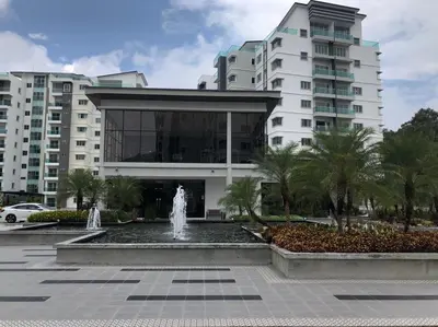 a building with a fountain in front of a building at Meena's Apartment @ The Quintet in Cameron Highlands