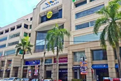a large building with palm trees in front of it at 118 Island Plaza Suite City8 by Joal in Tanjong Tokong