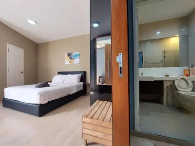 a bedroom with a bed and a sink and a mirror at 118 Island Plaza Suite City8 by Joal in Tanjong Tokong