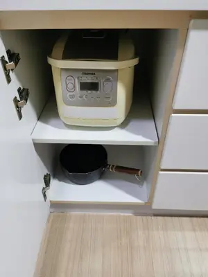 a kitchen cabinet with a toaster oven and a bowl at 118 Island Plaza Suite City8 by Joal in Tanjong Tokong