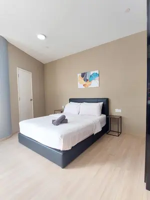 a bedroom with a large bed with white sheets at 118 Island Plaza Suite City8 by Joal in Tanjong Tokong