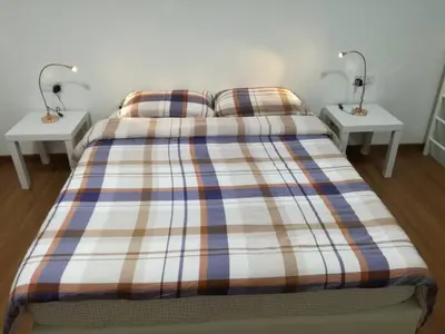 a bedroom with a bed with two lamps on two tables at On Cloud 9 @ CEO by Joal in Bayan Lepas