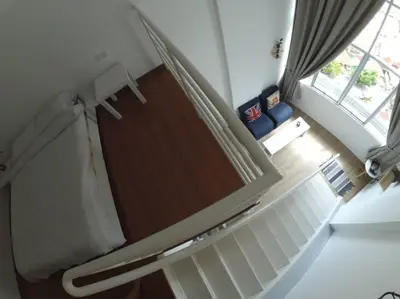 a living room with a staircase with a window at On Cloud 9 @ CEO by Joal in Bayan Lepas
