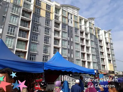 a blue tent in front of a large building at Penthouse - Secret Garden de Cameron, Night Market in Tanah Rata
