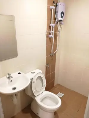 a bathroom with a toilet and a sink at One Residence Sekinchan \u9002\u8015\u5e84\u65e0\u654c\u6d77\u666f in Sekincan