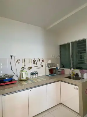 a kitchen with white cabinets and a counter top at One Residence Sekinchan \u9002\u8015\u5e84\u65e0\u654c\u6d77\u666f in Sekincan