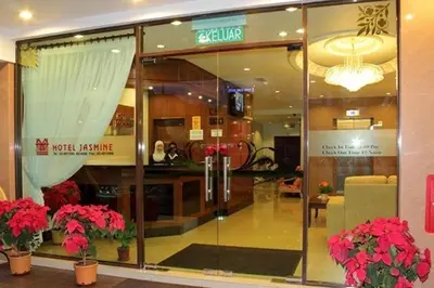 a store front with red flowers in a building at Jasmine Hotel in Cameron Highlands