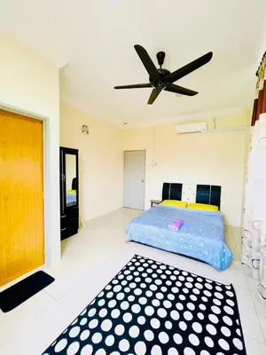 a bedroom with a bed and a ceiling fan at D Corner Islam Homestay in Kuala Kangsar
