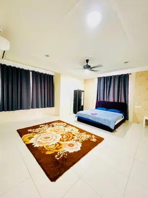 a bedroom with a bed and a rug on the floor at D Corner Islam Homestay in Kuala Kangsar
