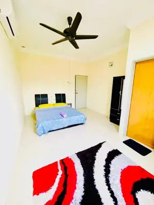 a bedroom with a bed and a ceiling fan at D Corner Islam Homestay in Kuala Kangsar